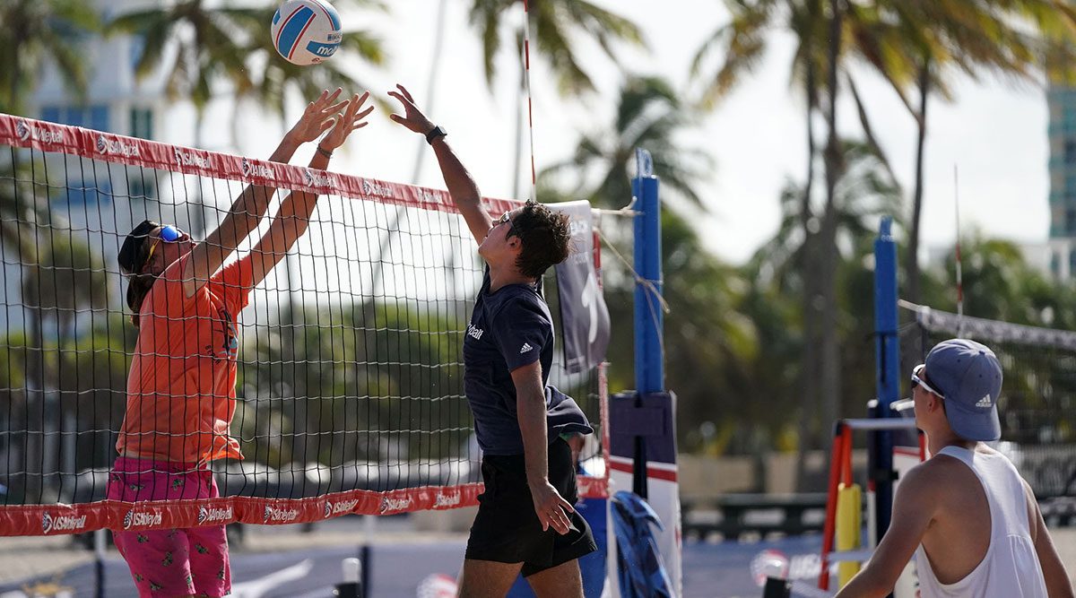 Boys playing beach volleyball