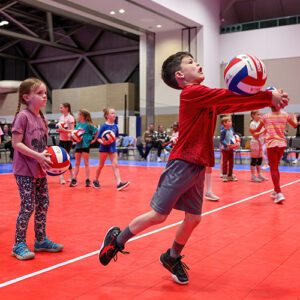 A young boy digs the ball
